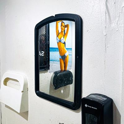 Restroom mirror and dispenser