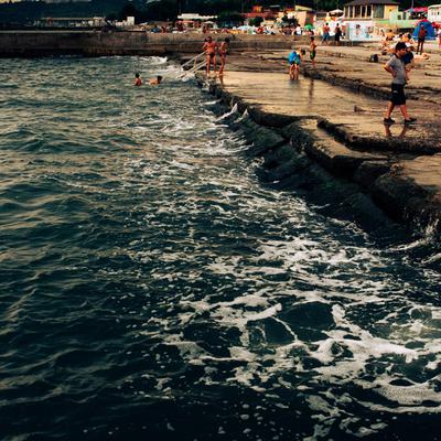 Bathers on a sea wall
