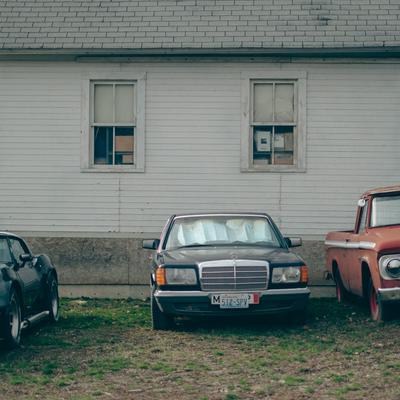 Cars outside a clapboard house