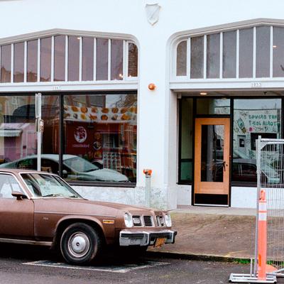 Car outside storefronts